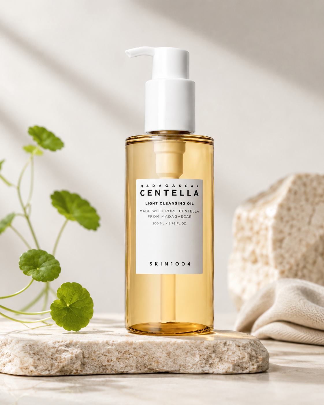 SKIN1004 Madagascar Centella Light Cleansing Oil 200ml on a neutral background with a plant and towel.