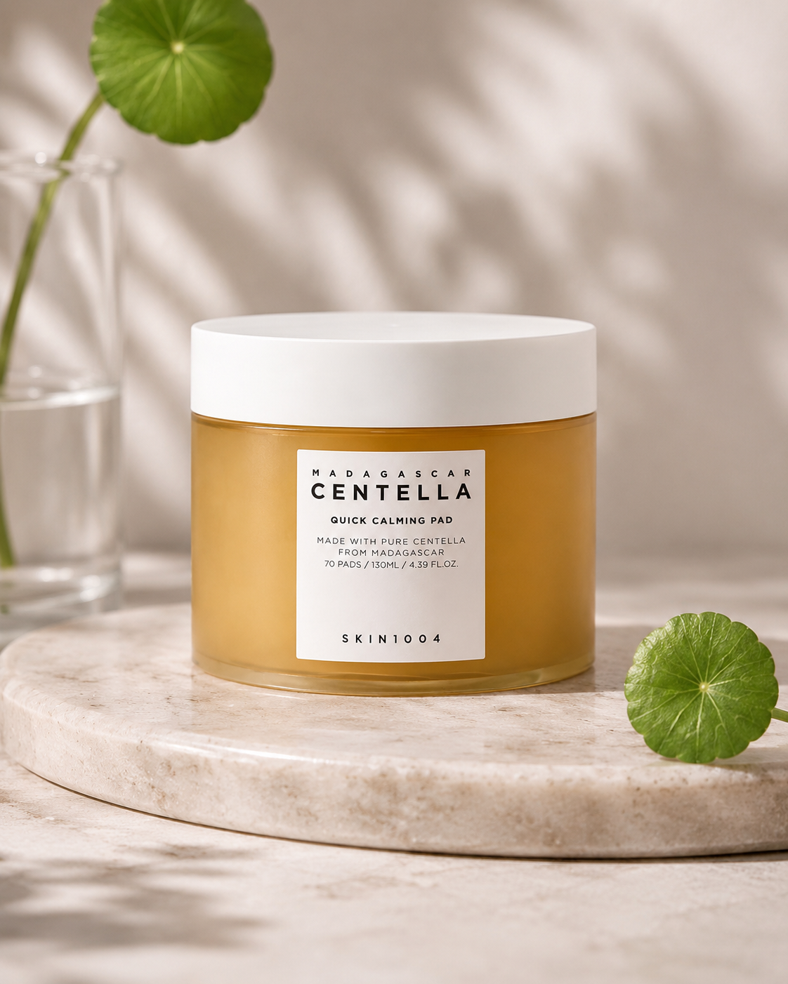 SKIN1004 Madagascar Centella Quick Calming Pad 70 Pads (130ml) on a marble surface with green leaves.