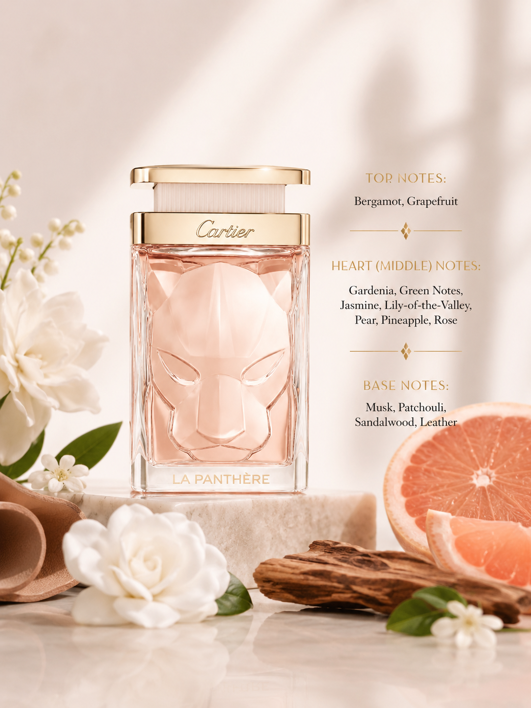 Cartier La Panthère perfume bottle in a pale pink glass with a gold cap, styled on a marble surface with white flowers, cinnamon bark, and a grapefruit slice. Text on the right lists the fragrance's top, heart, and base notes.